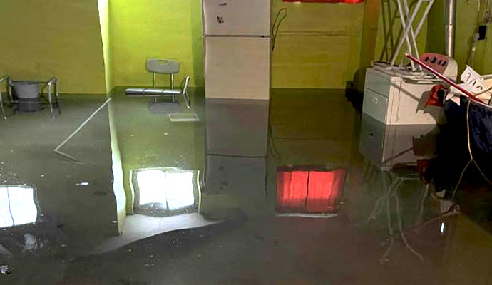 A flooded basement has water covering the floor