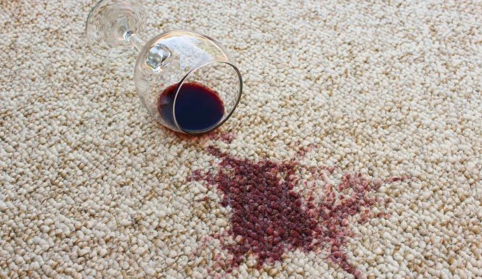 Spilled wine from cup on carpet