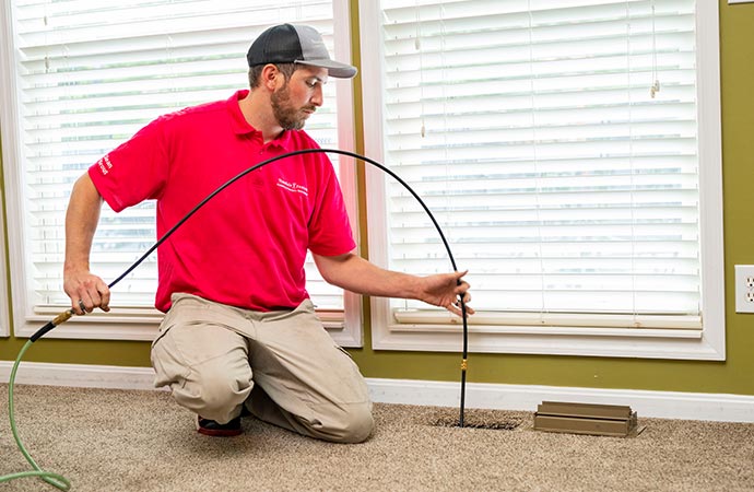 Vacuum cleaning carpets to keep them clean and fresh.