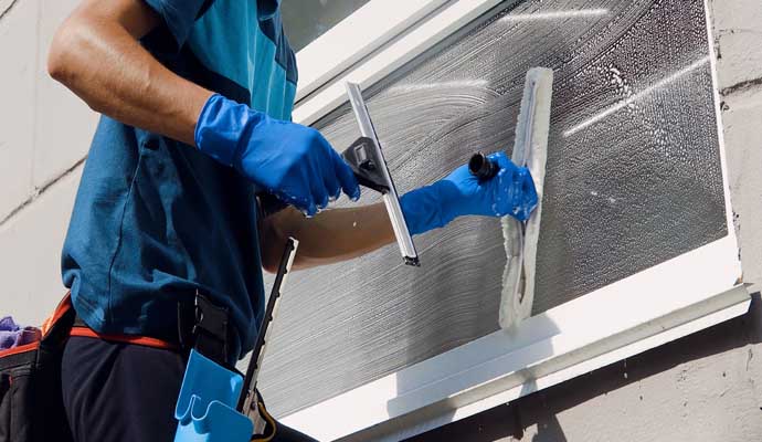 A person cleaning a window