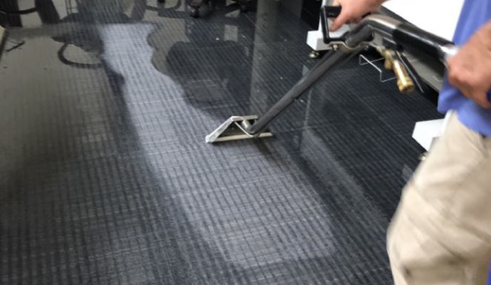 A person cleaning water off the floor