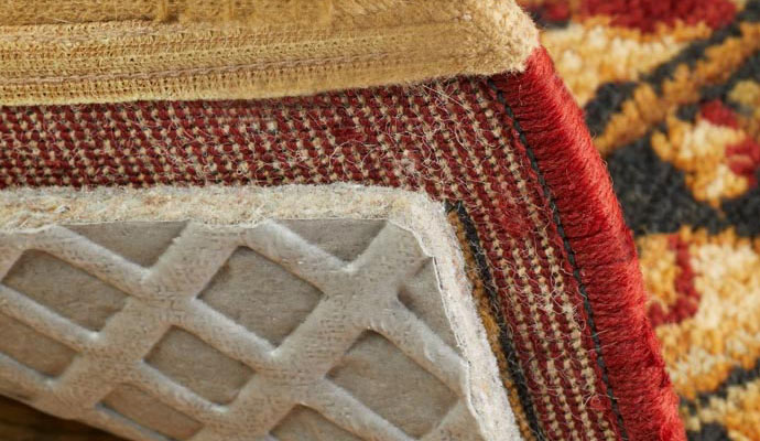 A corner of rug with a visible rug pad