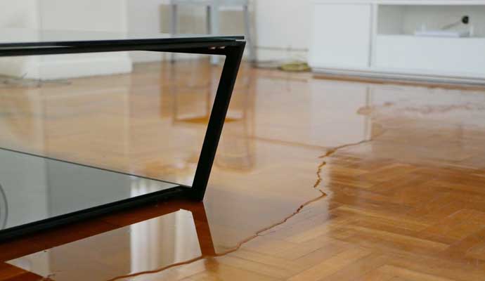 Flooded wooden floor in the room