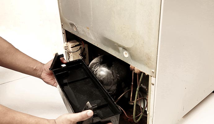 professional worker fixing refrigerator