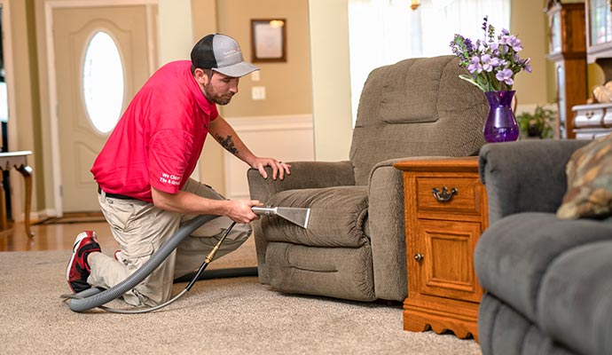 Professional worker cleaning sofa in Sarasota & Laurel, FL